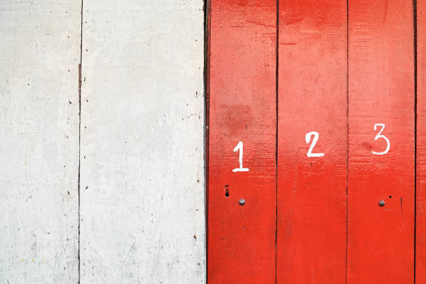 istock Big white numbers on strong red colored panels 1206008476