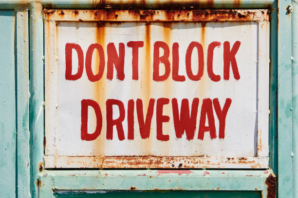istock Rusty sign with writing 'Don't block driveway' 1206008766