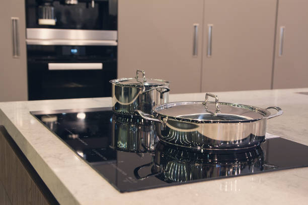 istock Pots in modern kitchen with induction stove. Interior 1206019041