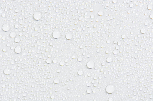 Close up water drops on black tone background. Abstract white gray wet texture with bubbles on plastic PVC surface or grunge. Realistic pure water droplets condensed. Detail of canvas leather texture