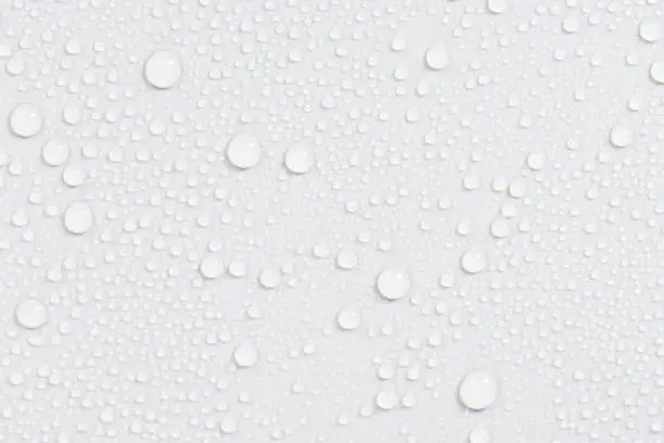 Close up water drops on black tone background. Abstract white gray wet texture with bubbles on plastic PVC surface or grunge. Realistic pure water droplets condensed. Detail of canvas leather texture