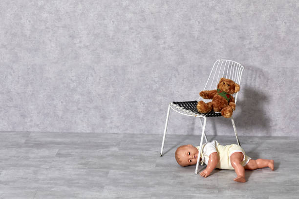 istock White metal chair, teddy bear and boy puppet on gray background 1206020502