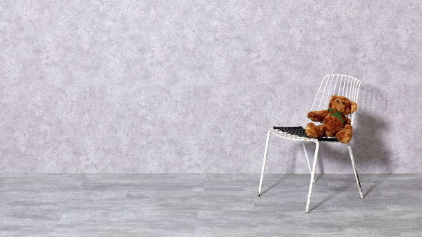 istock White metal chair and teddy bear on gray background 1206020799