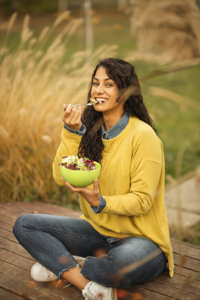 istock Woman resting and eating fresh salad 1206021881