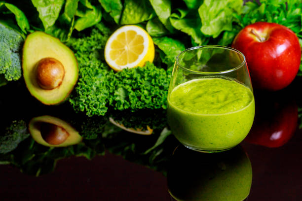 istock Fresh vegetable smoothie with ingredients on black background. 1206022896