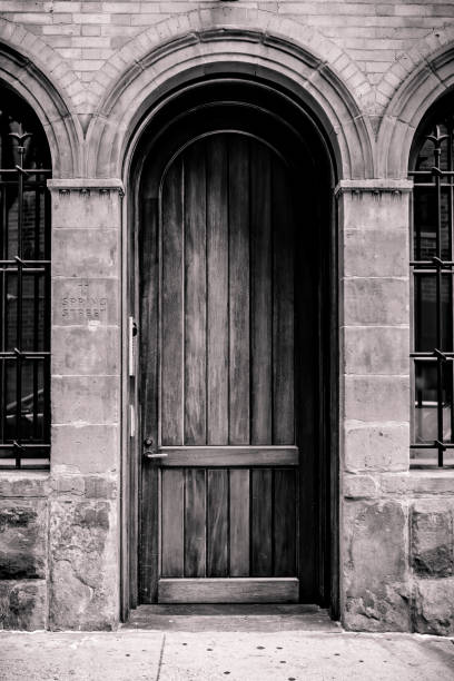 Beautiful arched wood door surrounded by stone arches