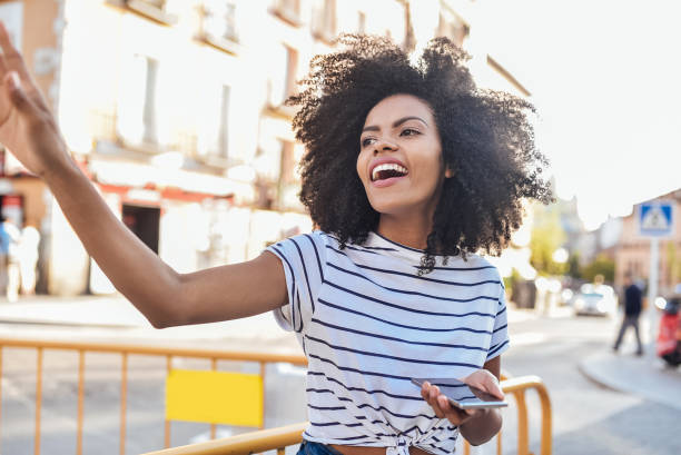 istock Afro girl calling a taxi 1206024030