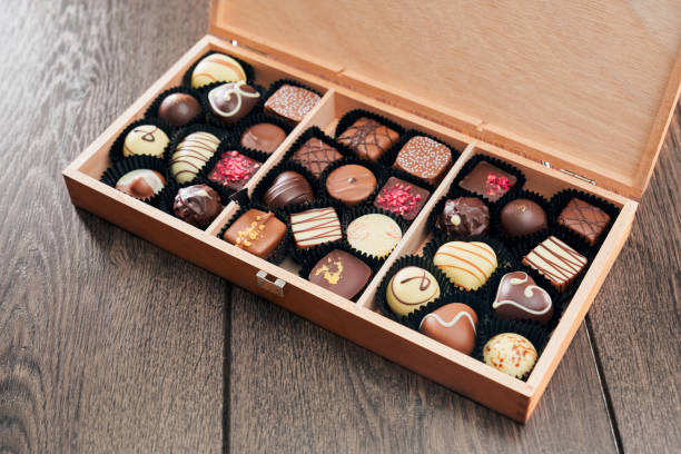 istock Different chocolate candies in wooden box. 1206024619