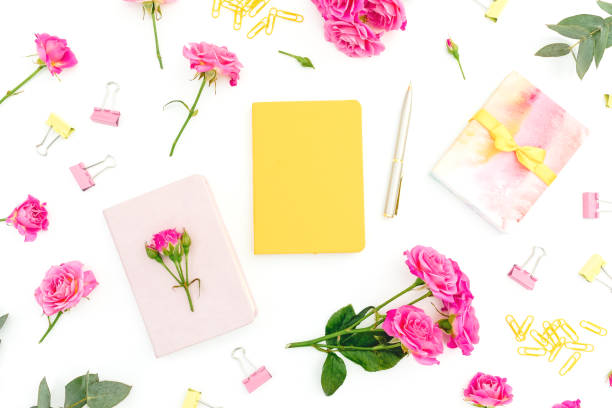 Conceptual composition with notebook, eucalyptus, gift and roses on white background. Flat lay.
