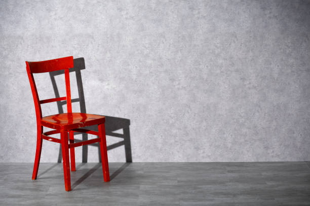 Red wooden chair on gray background