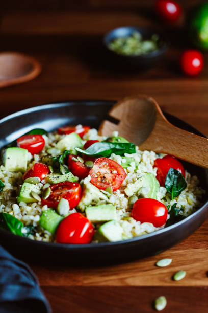 istock Healthy salad with bulgur, avocado, spinach and cherry tomatoes. 1206026326