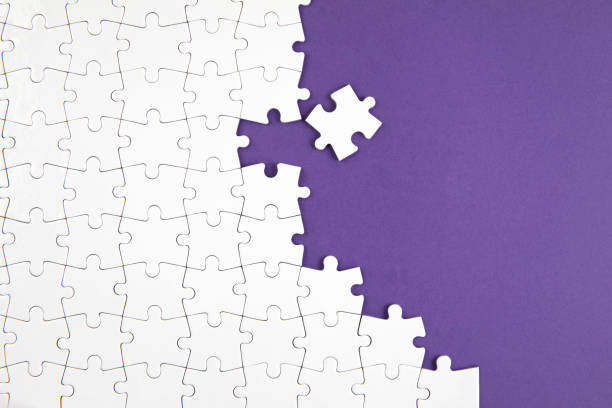 istock Jigsaw Puzzle on Purple Background 1206026527