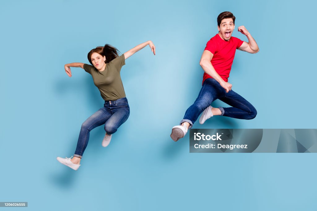 Full Length Photo Of Funky Funny Crazy Two People Students Sportive Team  Man Woman Jump Practice Fighting Sport Exercise Kick Hands Wear Casual  Style Outfit Isolated Blue Color Background Stock Photo -
