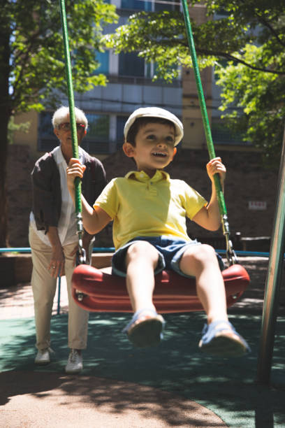 istock Child having fun at the public park on a seesaw 1206026729