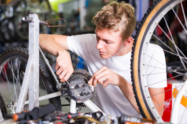 istock professional man repairing bicycles in the workshop 1206028387