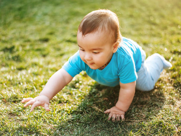 istock Happy baby boy on grass 1206030143