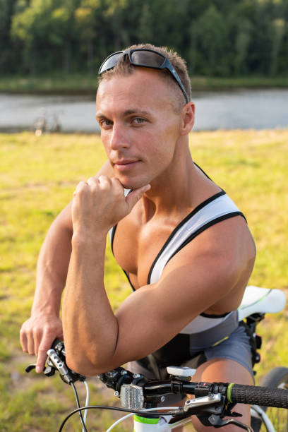 Man near a bicycle. On nature in the field.