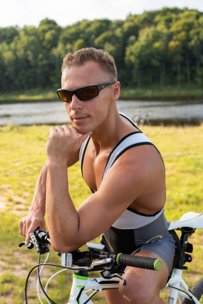 istock Man near a bicycle. On nature in the field. 1206031129