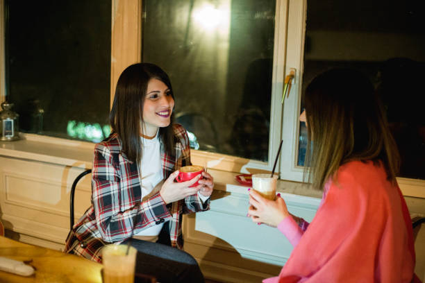 istock Pretty women talking and drinking coffee inside coffee shop 1206031141