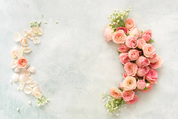 istock Flowers  frame with various  roses,  and petals on a rustic background. Women's Day,  greeting card or wedding invitation 1206032853