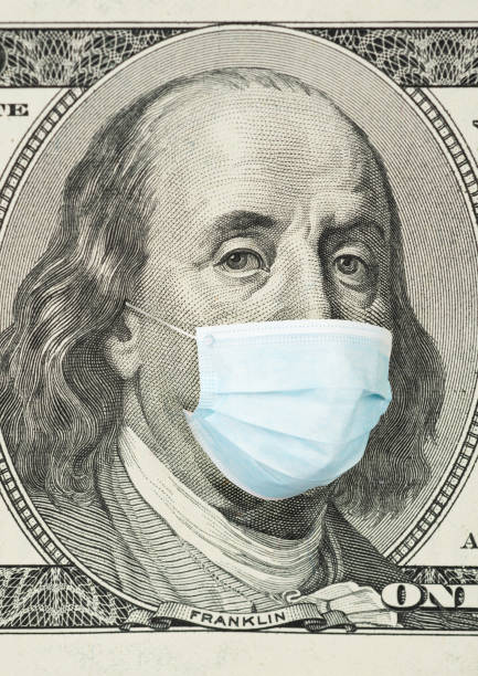 istock 100 dollar banknote with medical mask 1206034126