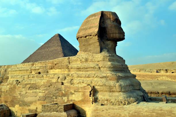 istock Sphinx is sitting in the desert for ages looks like camel with pyramid on back 1206034509