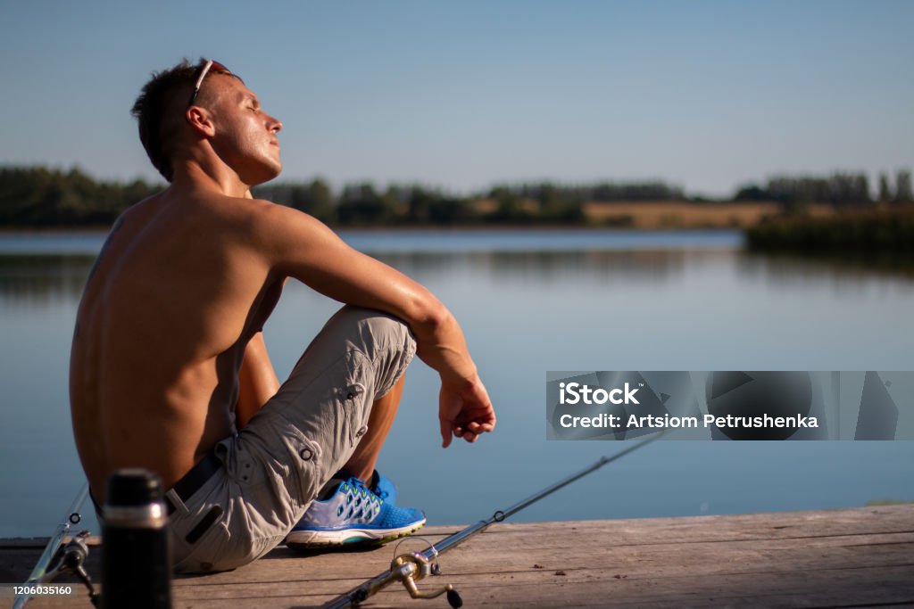 A Beautiful Man With A Bare Cake With A Fishing Rod Stock Photo