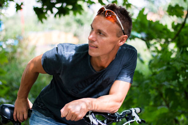 istock A man looks in the side, dipped on a bicycle 1206035520