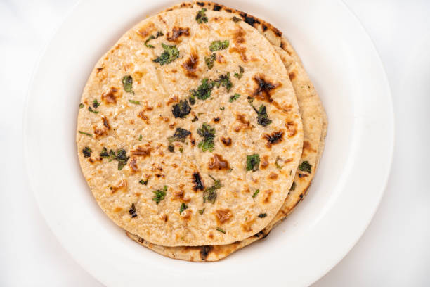 istock Chapatti (roti) garnished with coriander leafs served in white plate 1206036519