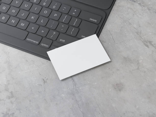 istock White Business Card Mockup on black digital tablet keyboard on concrete table 1206038696