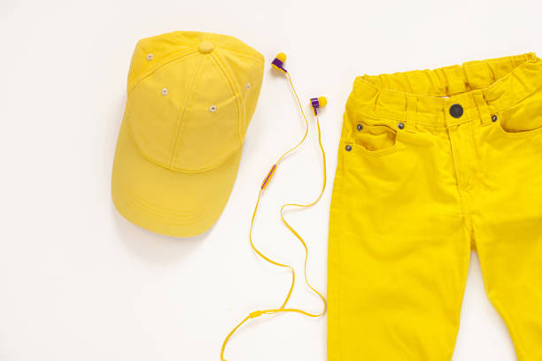 Yellow flatlay jeans, baseball cap and headphones on white background copy space,top view.Spring summer fashion clothing Yellow flat lay jeans, baseball cap and headphones on white background copy space,top view. Spring summer fashion, capsule wardrobe concept.Sport casual style,trendy bright colors clothing accessories spring fashion stock pictures, royalty-free photos & images