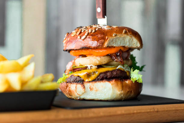istock Fresh flame grilled bacon cheeseburger on wooden board 1206042358