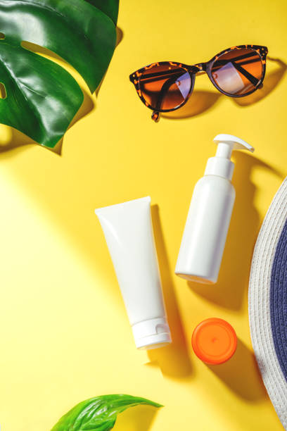 istock Sunprotection objects. Woman's hat with sunglasses and protection cream SPF Flat lay on yellow background. Beach accessories. Summer Travel Vacation Concept 1206042670