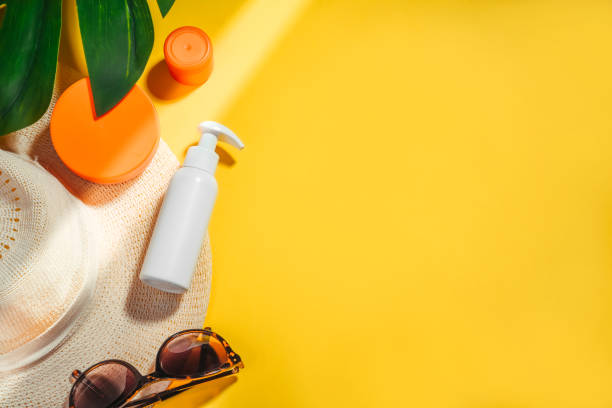 istock Sunscreen. Woman's hat with sunglasses and protection cream spf Flat lay on yellow background. Beach accessories. Summer Travel Vacation Concept 1206043247