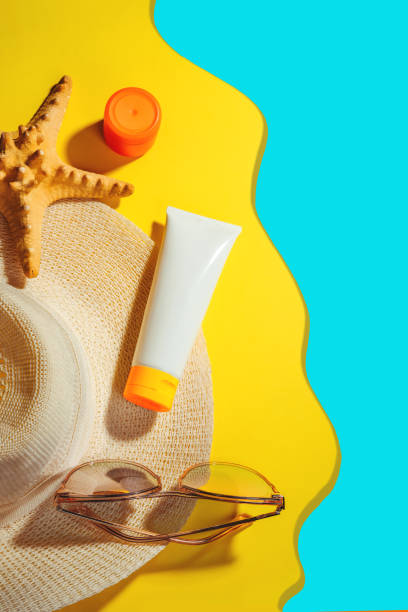 istock Sunprotection objects, sunscreen. Straw woman's hat with sun glasses and protection cream SPF Flat lay on yellow background. Beach accessories. Summer Travel Vacation Concept 1206043265