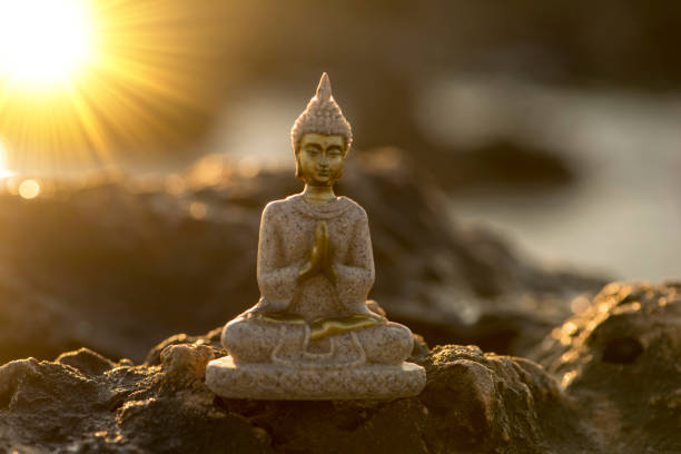 istock A buddha figure on a rock by the sea 1206043323