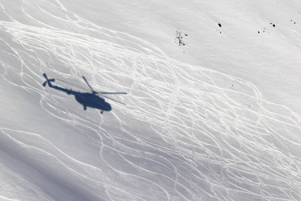 눈 덮인 오프 피스트 스키 슬로프에 헬리콥터에서 그림자 - rescue helicopter mountain snow 뉴스 사진 이미지