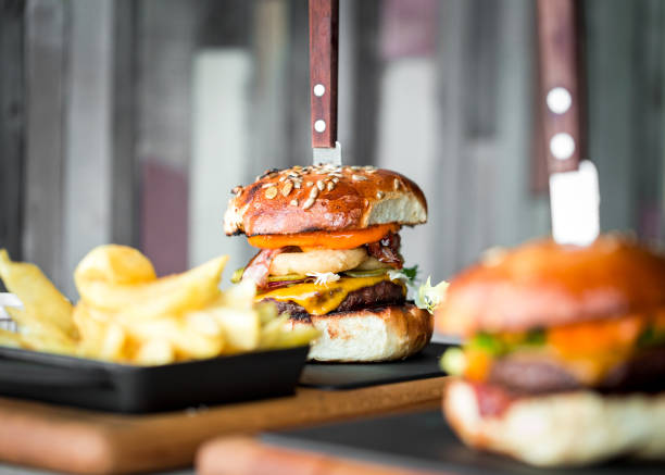istock Fresh flame grilled bacon cheeseburger on wooden board 1206043712