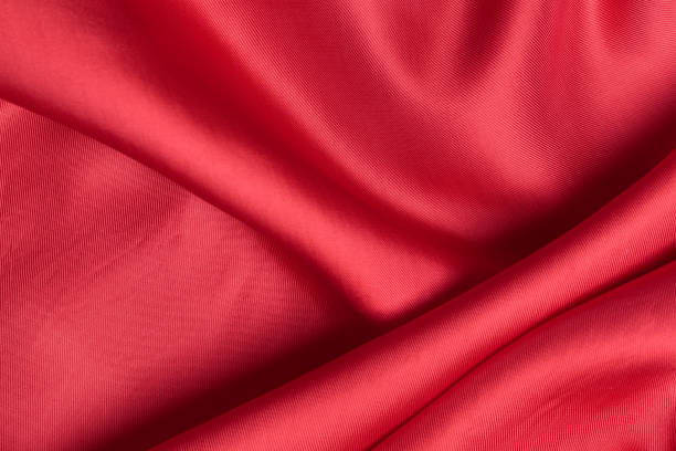 istock fabric texture. abstract background with soft waves. Smooth elegant red silk or satin luxury cloth 1206045250