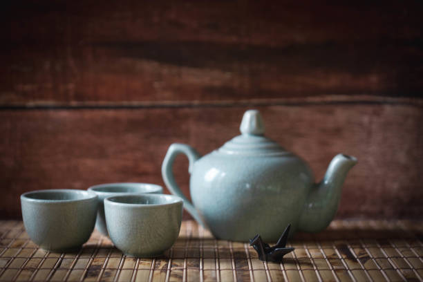 istock Blue ceramic teapot and tea cups on bamboo mat and ceramic paper crane 1206047269