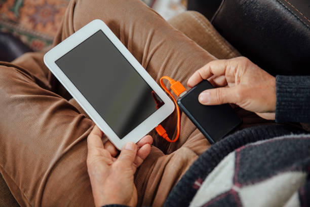 Man Charging digital tablet  portable charger