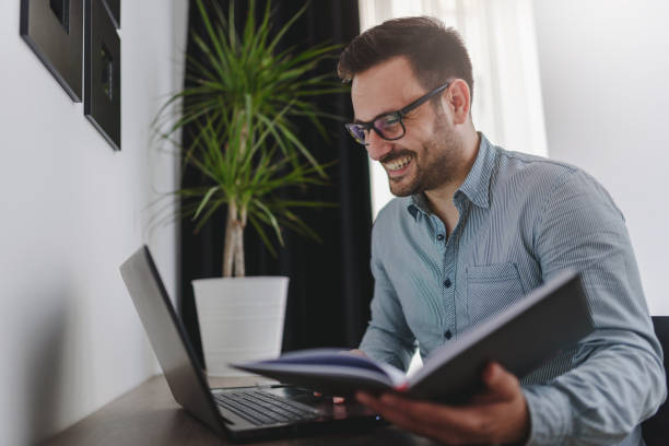 istock Man using laptop computer, working at home. Worried about finances. 1206050253