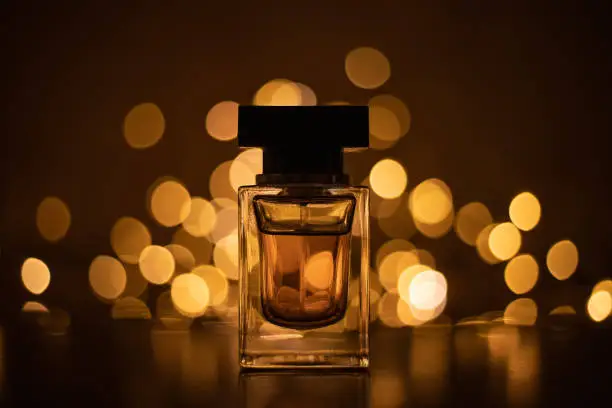 Photo of Perfume bottle on bokeh lights background