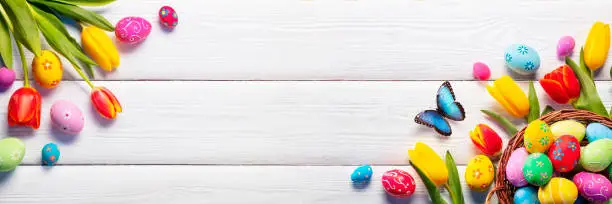 Easter - Painted Eggs In Basket And Tulips On White Plank