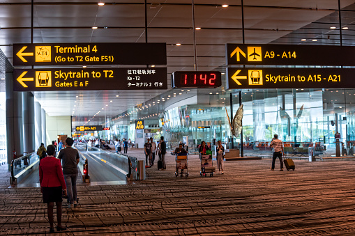 Airline passengers move from flight to flight at Changi International Airport in Singapore.
