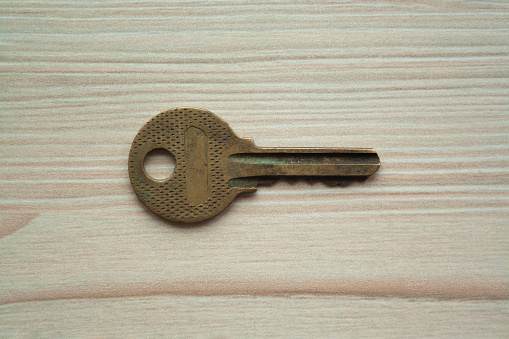 Close up macro shot of old rusty grunge key top view. Single key. Access, security, enter