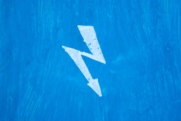 White sign danger electricity on steel blue painted wall in switchboard. Texture with paint stains and rusty
