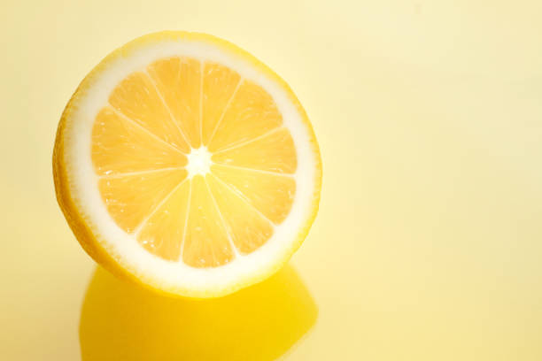 istock Sliced bright juicy lemon on a yellow background. 1206056790