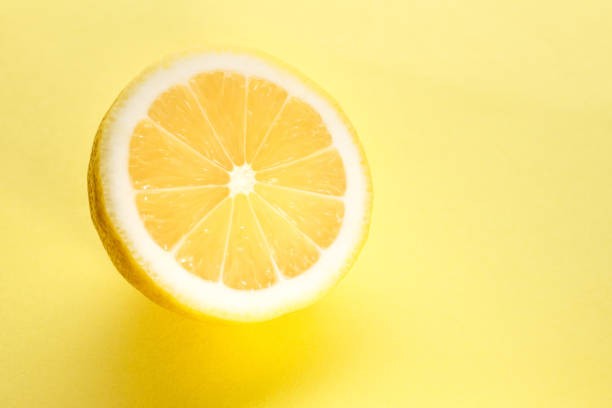 istock Sliced bright juicy lemon on a yellow background. 1206056798