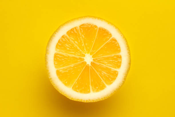 istock Sliced bright juicy lemon on a yellow background. 1206056801